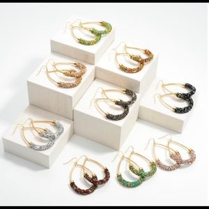 Rhinestone encrusted gold tone teardrop earrings.